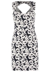 Kostym i svart och vitt med blommönster, ärmlös, knälång med breda axelband och ett nyckelhål i uringning.