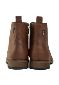 Brown vegan leather ankle boots with a smooth finish, zipper closure, and a block heel. Features a logo tag on the side.