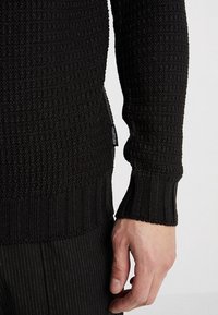 YOURTURN Stickad tröja - black