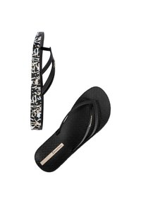 Chanclas negras con suela texturizada y dos tiras negras. La suela externa presenta un patrón abstracto en blanco y negro a lo largo del lateral.