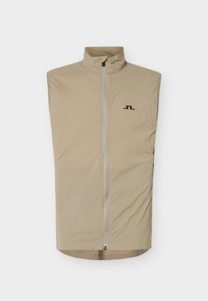 Beige mouwloos vest met een ritssluiting aan de voorkant en een klein zwart logo op de linkerborst, afgebeeld tegen een witte achtergrond.