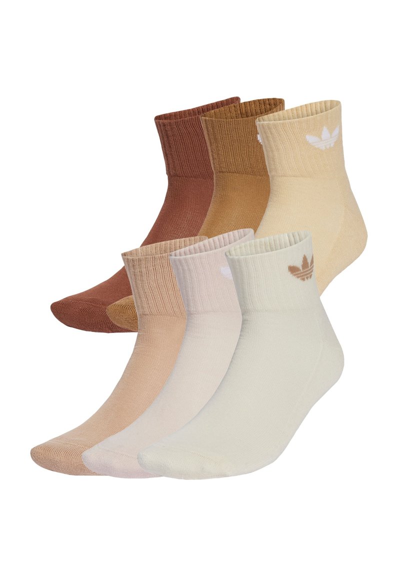 Pet par nogavic za gležnje v različnih zemeljskih odtenkih: rjava, bež in krema. Imajo rebraste manšete in majhen logotip v kontrastni barvi.