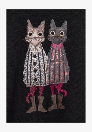 Embroidered patch featuring two cats in dresses: one with a leopard print and buttons, the other with a pink top and patterned skirt, both in brown boots.