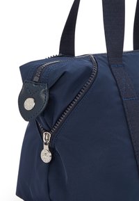 Navy blue fabric bag with a zipper closure, featuring a rounded shape, textured stitching, and a silver zipper pull with a logo detail.
