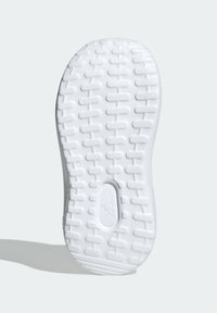 Semelle de chaussure blanche avec un motif texturé composé de rainures rectangulaires et d'accents circulaires, fabriquée en caoutchouc pour offrir adhérence et soutien.