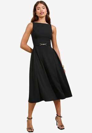 Black A-line dress with a fitted bodice and pleated skirt, featuring a gold-tone belt accent and sleeveless design. Smooth fabric texture.