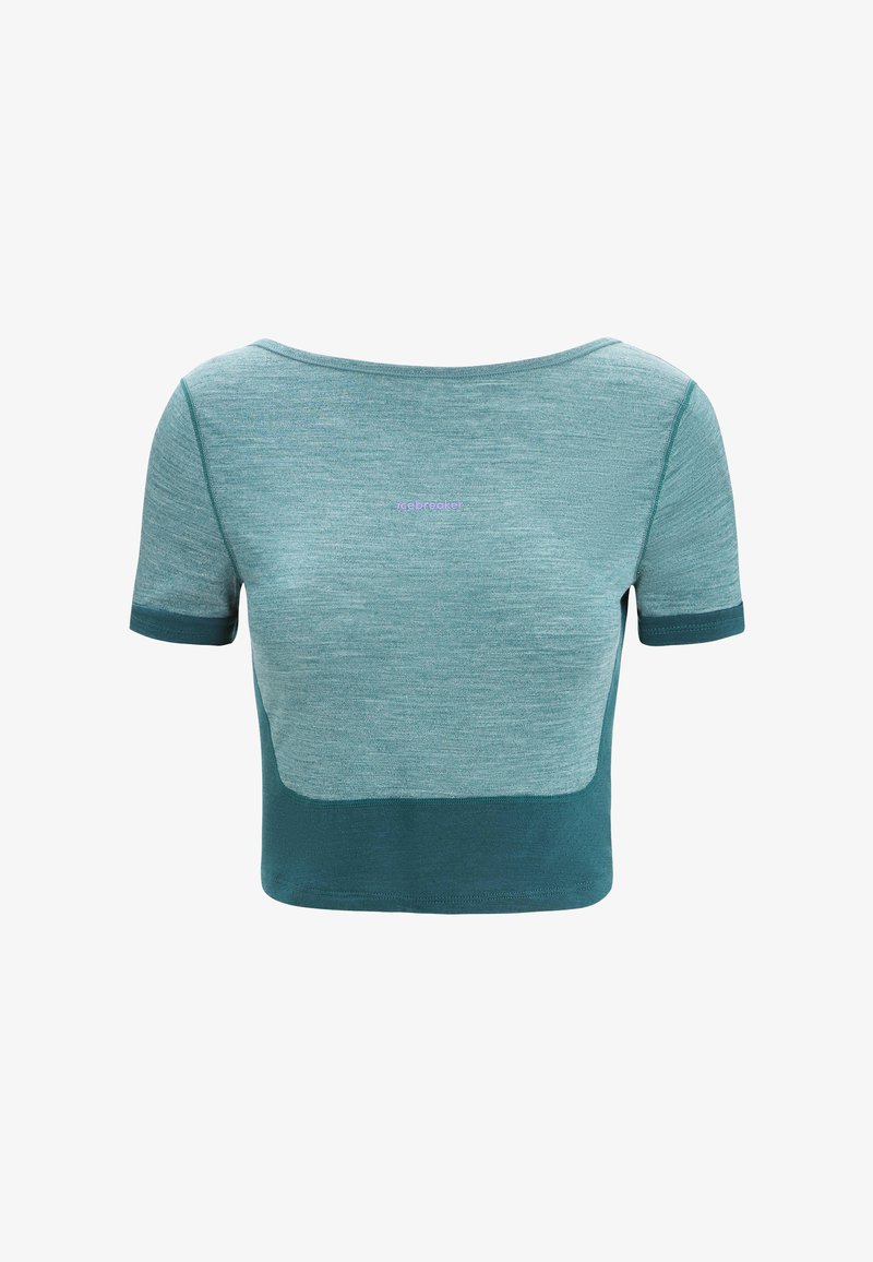 Teal cropped top with short sleeves, made of breathable fabric. Features a color-block design and subtle logo detail on the chest.