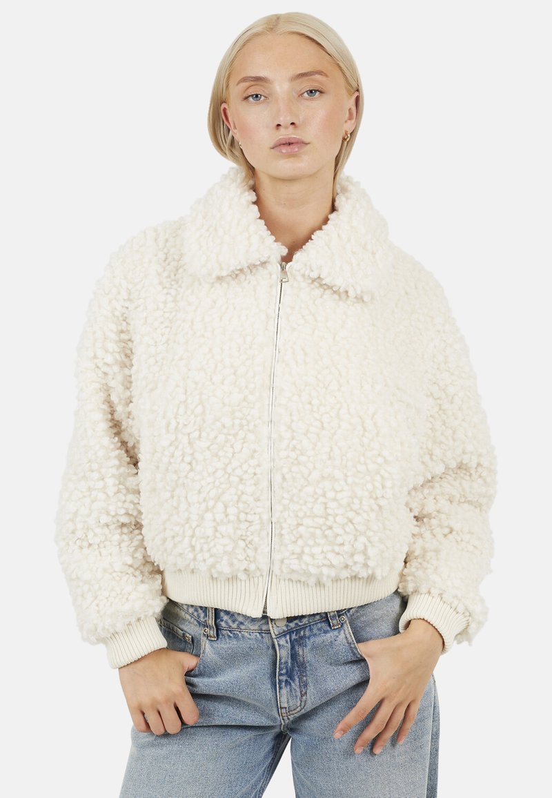 Crème-kleurige fleece bomberjack met een gestructureerd, fluffy oppervlak, voorzien van een met kraag en ribgebreide manchetten en zoom. Ritsluiting.