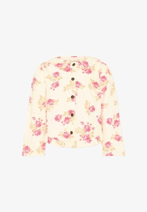 Blouse crème à manches longues avec imprimés de roses roses et beiges, boutons marron sur le devant, et large col rond.