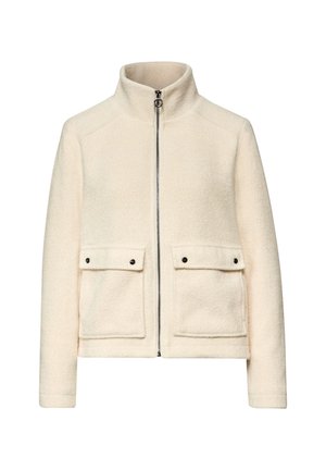 Krémově zbarvená bunda z texturované látky, s vysokým límcem, stříbrným zipem a dvěma předními kapsami se černými knoflíky.