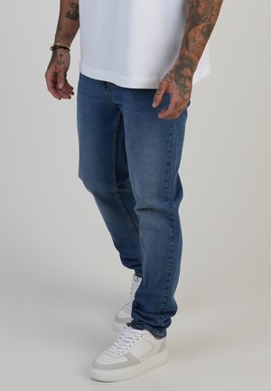 Jeans Tapered Fit - washed mid blue