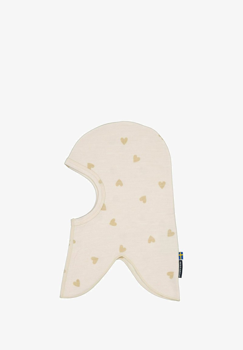 Lysbeige hat med små brune hjerte-mønstre, blødt stof, rund top, forlængede sider og en cirkulær åbning til ansigtet.