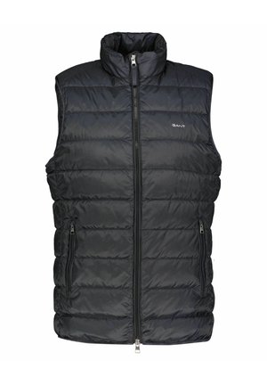 Veste sans manches matelassée noire avec fermeture éclair devant, deux poches zippées, col montant et petit logo GANT sur la poitrine.