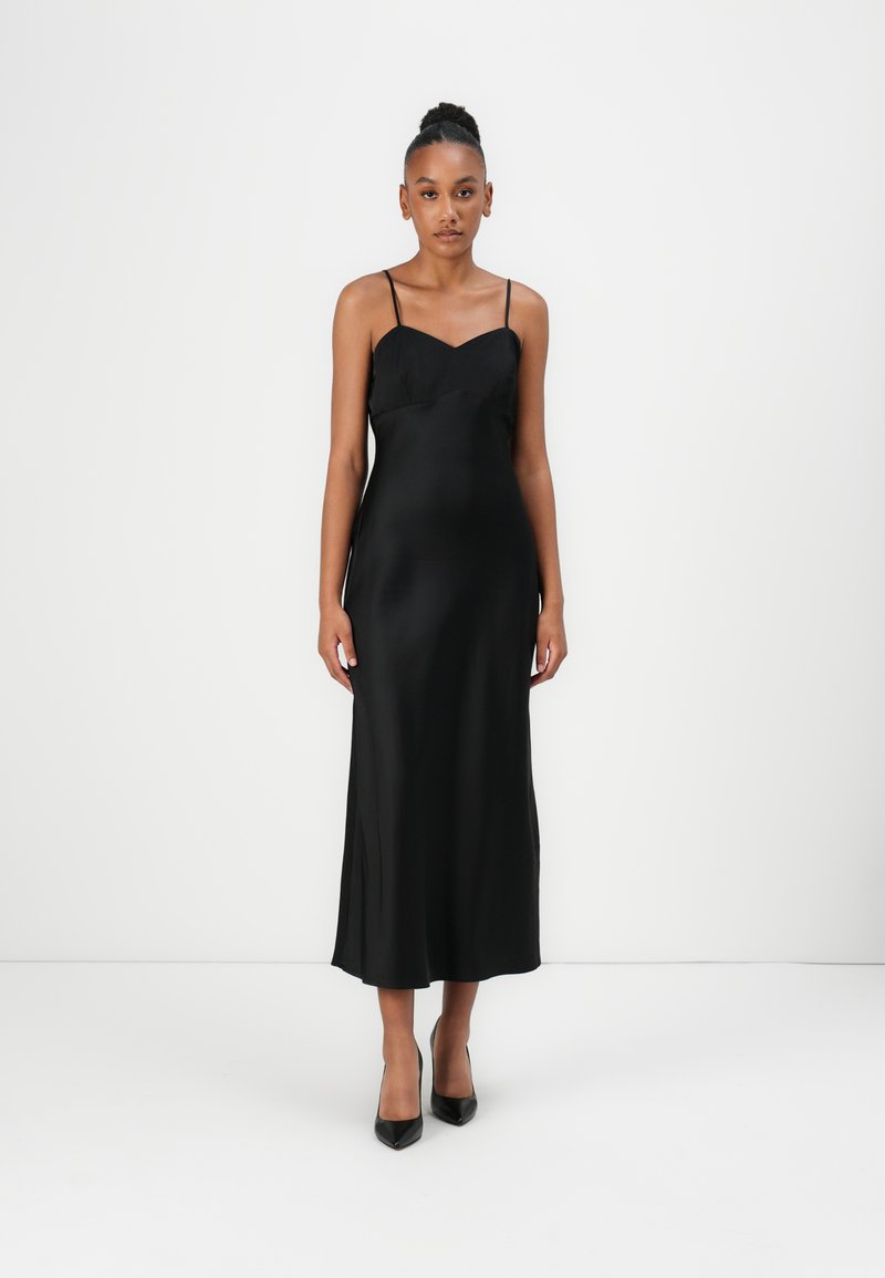 Black satin slip dress with a V-neckline and thin shoulder straps, featuring a straight cut and a smooth, glossy texture.