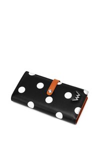 Black wallet with white polka dots, featuring a brown leather strap and silver hardware detail. Smooth texture with contrasting colors.