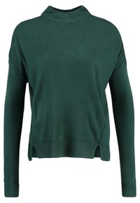 Pull en tricot vert à manches longues, col montant, fentes latérales et ourlet côtelé. Texture douce et coupe décontractée.