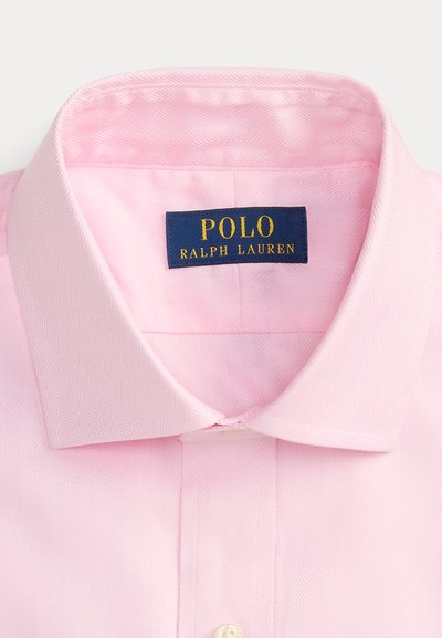 Roze overhemdkraag met een blauw label waarop Polo Ralph Lauren staat in gele letters.