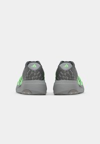 Gray athletic shoes with green accents and a patterned upper. Lightweight design, cushioned sole, and flat heel for stability.