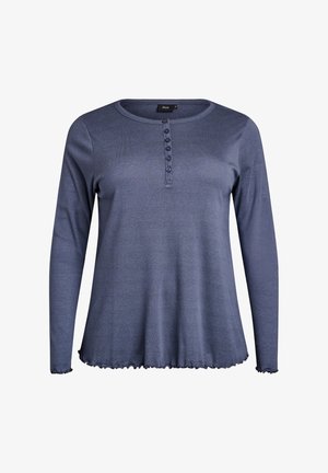 Mėlynas ilgomis rankovėmis marškinėliai, pagaminti iš minkštos medžiagos, su apvaliu iškirpimu, mygtukų užsegimu ir banguotu apvadu. Atsitiktinė prigludimo forma ir tekstūruotas paviršius.