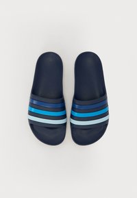 Navy slide sandals with textured material, featuring five horizontal stripes in varying shades of blue and light blue. Flat, open design.