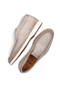 Beige suede slip-on shoes with a white sole, featuring stitched detailing and a smooth texture. The interior is tan with brand labeling.