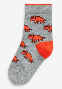 Graue Socken mit orangefarbenen Dinosaurier-Mustern sowie einem kontrastierenden orangen Zehen- und Bündchenbereich. Hergestellt aus weichem Material mit einer strukturierten Oberfläche.