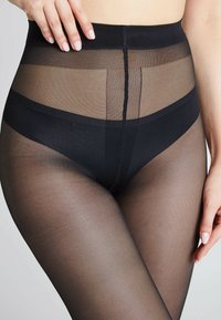 Collant neri trasparenti con vita alta, caratterizzati da una texture liscia e una finitura semi-trasparente. Include un design distintivo per la cintura.