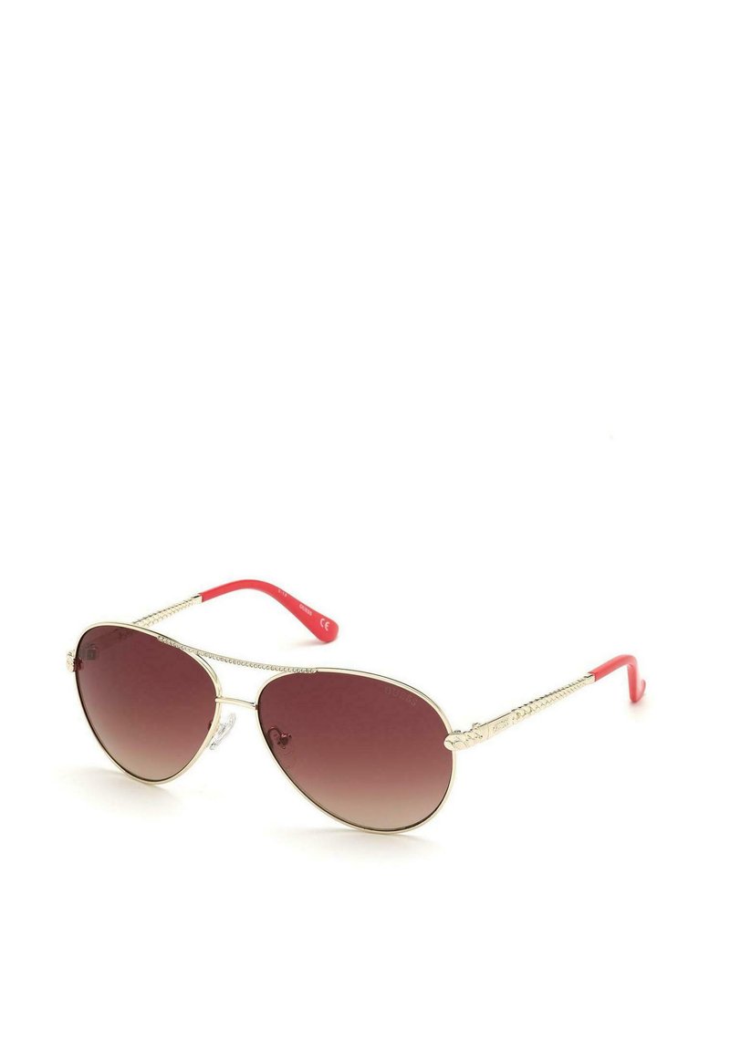 Gafas de sol aviador con lentes marrones en degradado, montura de metal dorado y brazos de plástico rosa con un diseño texturizado.