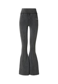 Leggings acampanados grises hechos de tela suave, con una cintura alta y un detalle sutil de logo en la parte delantera. Textura lisa con un diseño ajustado.