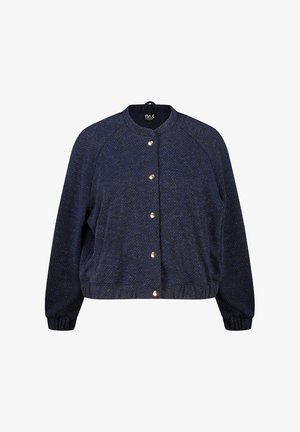 Blouson aviateur bleu marine en tissu texturé, boutons-pression dorés, poignets côtelés et col rond. Silhouette bouffante et coupe décontractée.