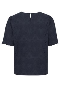 Blouse bleu marine avec un motif en œillets texturé, des manches courtes à bords festonnés et une fermeture en forme de trou de serrure au dos.