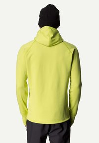 Hooded sweatshirt in bright yellow fabric, featuring long sleeves, a relaxed fit, and a smooth texture, paired with a black knitted beanie.
