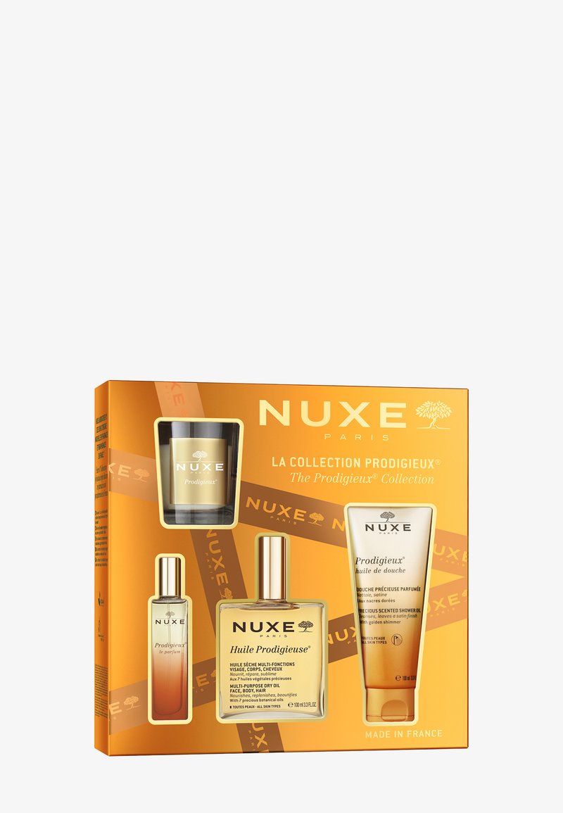Il set della collezione NUXE Prodigieux in scatola dorata include una candela, olio multiuso e olio doccia; contenitori trasparenti, branding elegante.