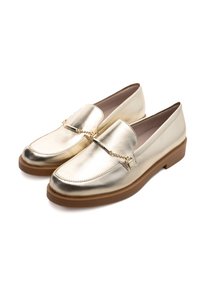Gold metallic loafers with a rounded toe, slip-on design, and chain accent across the vamp. Features a brown rubber sole for traction.