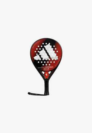 Black and red padel racket with a round shape, perforated surface, prominent white logo, textured grip, and wrist strap detail.