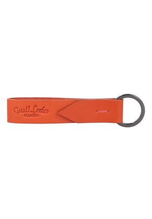Orange leather keychain strap with embossed "Gusti Leder studio" text and a metal keyring attached at one end.
