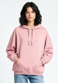 Felpa con cappuccio rosa realizzata in morbido cotone misto, con tasca a marsupio, cappuccio con coulisse e polsini e orlo a costine. Design a vestibilità rilassata.