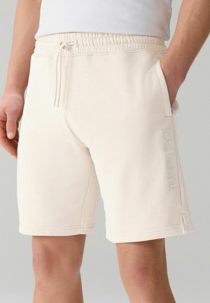 Next, REGULAR FIT - ACTIVE TRAINING DIVISION SHORTS  . - Tracksuit bottoms - ecru white