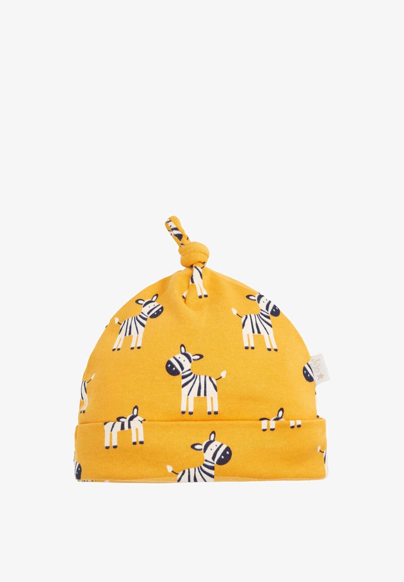 Keltainen puuvillahattu, jossa on solmu päällä, ja se näyttää musta-valkoisia seepra-kuvioita tasaisella taustalla. Pehmeä rakenne.