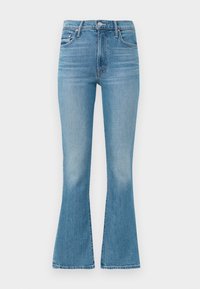 Light blue flared jeans made from denim, featuring a high waist, five-pocket design, and minimalistic stitching with a faded finish at the hem.