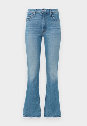 Light blue flared jeans made from denim, featuring a high waist, five-pocket design, and minimalistic stitching with a faded finish at the hem.