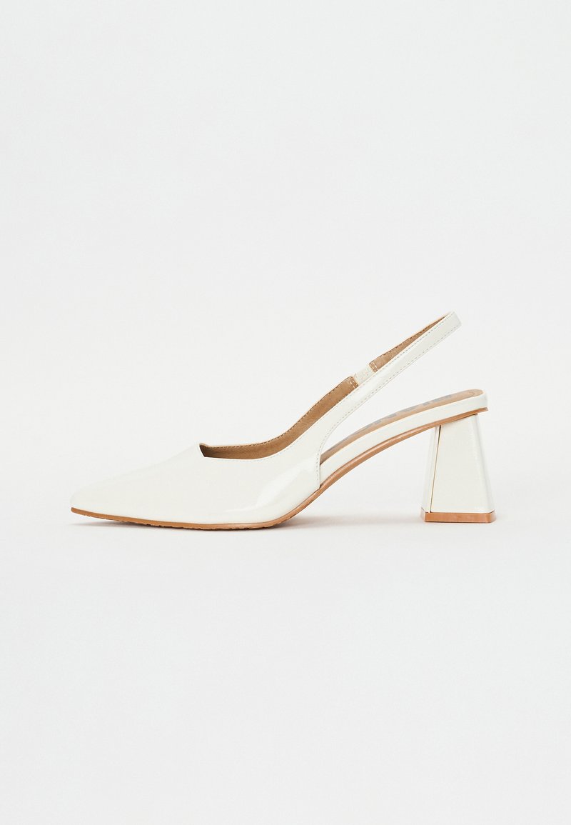 White patent leather slingback shoe with a pointed toe and a geometric block heel. Interior features a tan insole and minimal side cutouts.