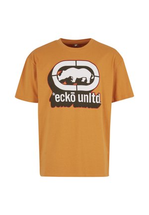 Lühikeste varrukatega oranž t-särk, mis on valmistatud puuvillast, sisaldab silmapaistvat musta ja valget graafilist logosid, millel on ninasarvikukujutis ja tekst selle all.