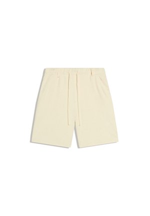 Beige Freizeithose mit elastischem Bund, Kordelzug und Seitentaschen, flach auf weißem Hintergrund dargestellt.