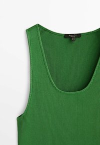 Green ribbed tank top made of stretchy fabric, featuring a scoop neckline and finished edges, with a tag visible at the back.