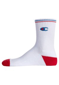 Weiße Baumwollsocke mit gerippter Textur, roten Akzenten an Zehen und Ferse sowie blauen und roten Streifen am oberen Rand. Besitzt ein blaues Logo an der Seite.