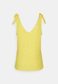 Gul ärmlös topp med djup V-ringning, med texturerad tyg med diamantperforeringar och knytband vid axlarna.