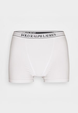 Boxer-briefs blancs avec une taille élastique noire portant le texte "BOLO RALPH LAUREN". Fabriqués en tissu lisse et extensible.