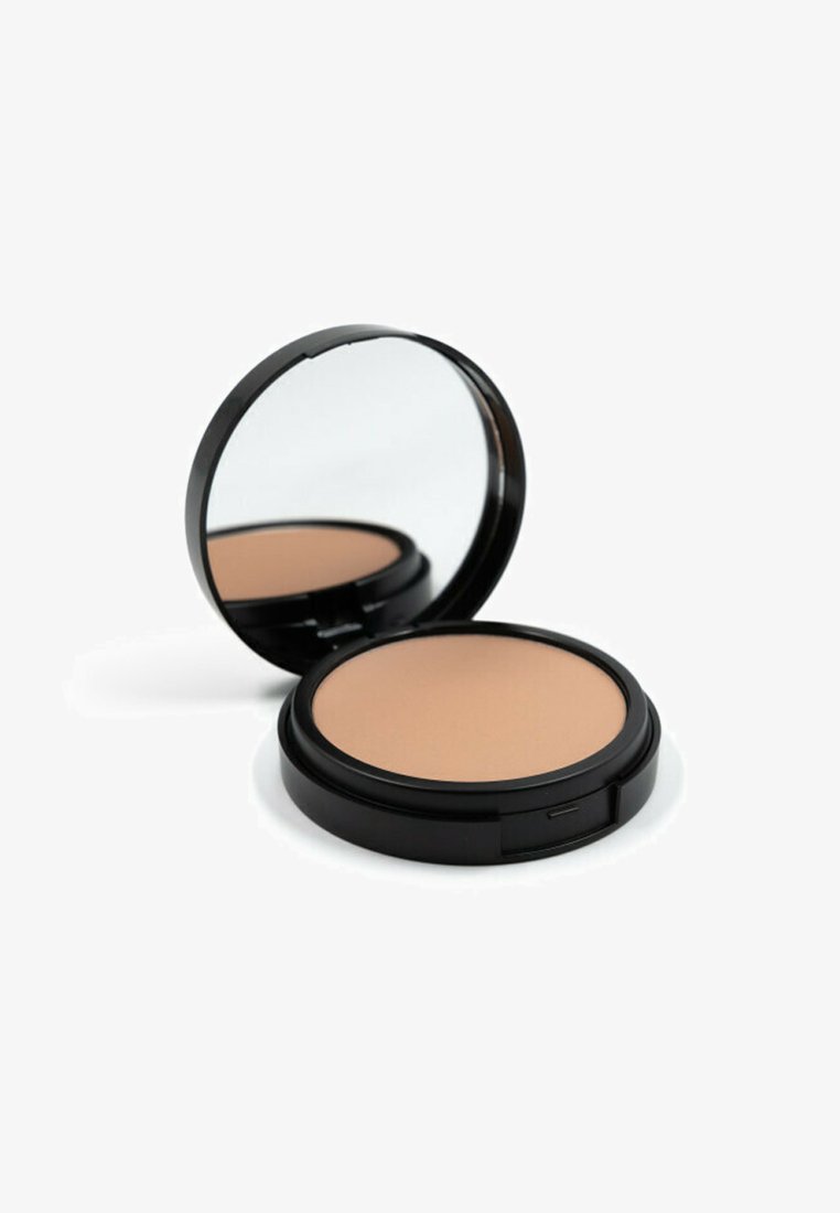 Cofanetto compatto nero in polvere con specchio; presenta una polvere compatta beige liscia all'interno. Forma circolare con elementi di design eleganti.