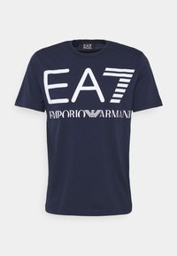 Navy blue cotton T-shirt featuring white printed text "EA7 EMPORIO ARMANI" in varying font sizes and styles. Crew neckline, short sleeves.